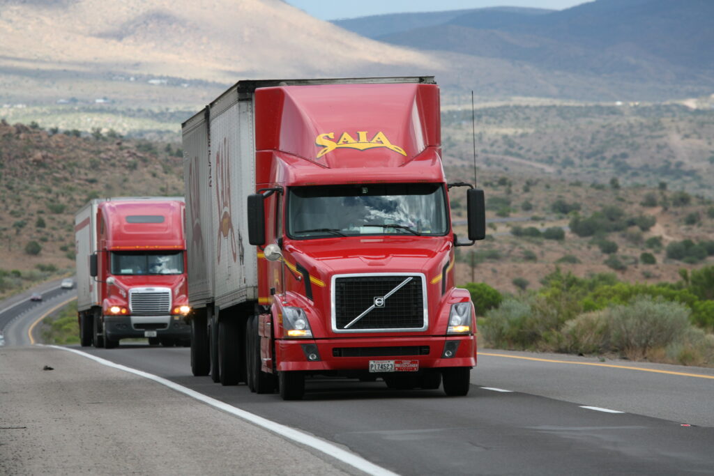 Red Trucks Driving on Road